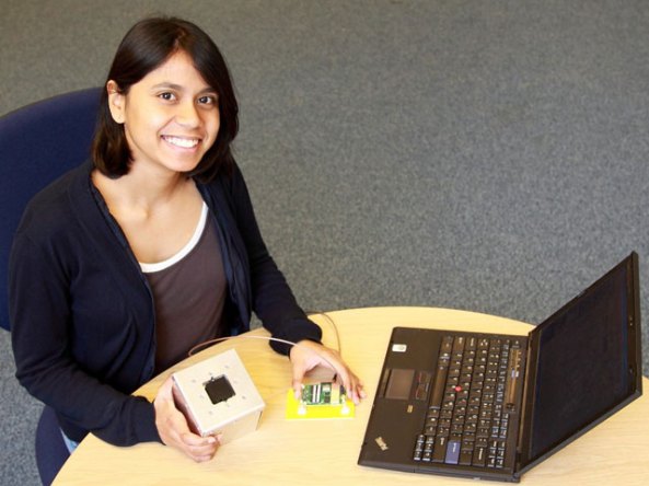 Talini holding a mockup of a cubesat (for testing antenna perfomance)