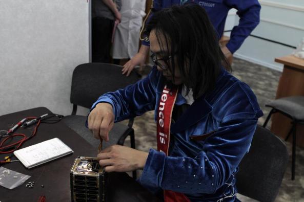 Hojun Song DS1SBO performing final assembly of OSSI-1 satellite on April 9, 2013